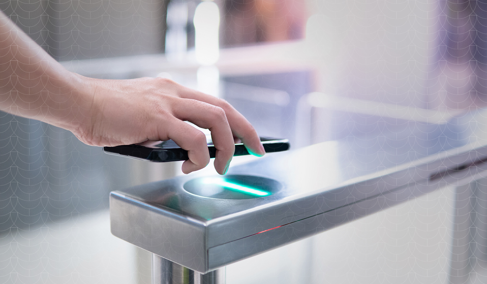 Person scanning a smartphone over a contactless access control reader at a secure entry gate.