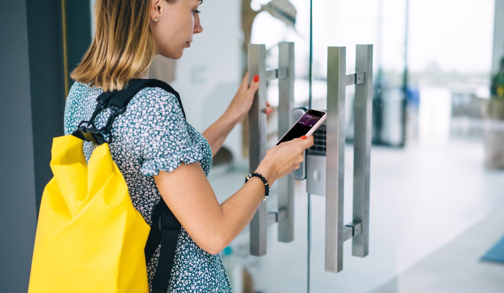 woman opening a door with acre security badge on her smartphone