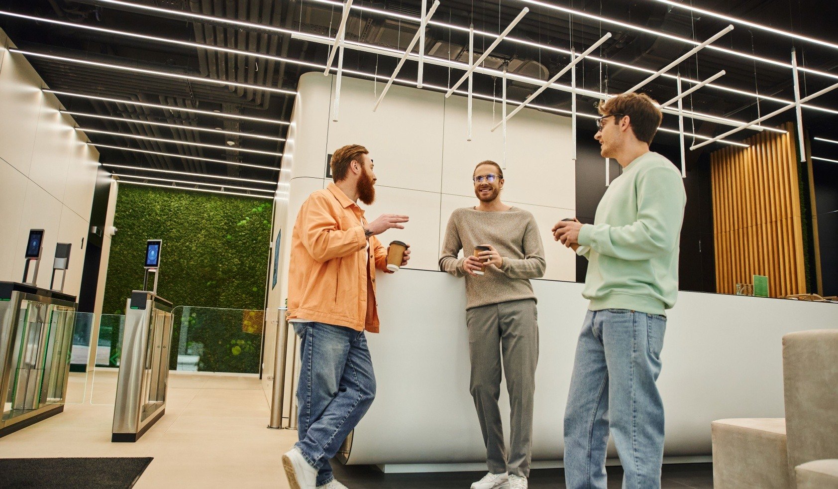 3 men talking at a lobby